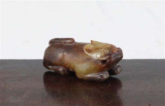 A Chinese yellow and brown jade figure of a recumbent of a lion dog, Ming dynasty or earlier, 5.7cm, calcification